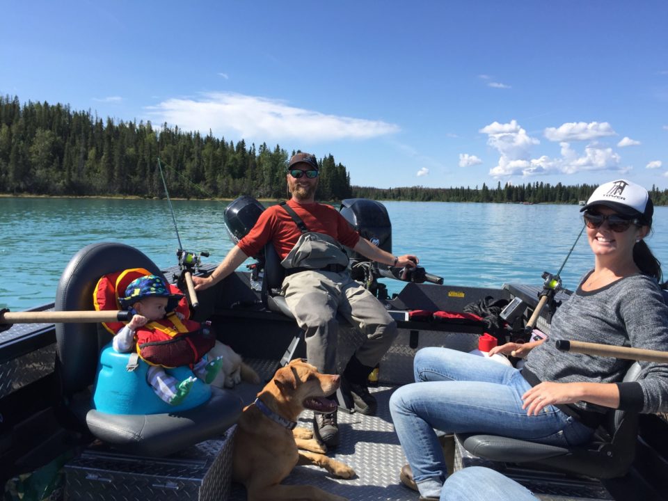 family and dog on fishing boat