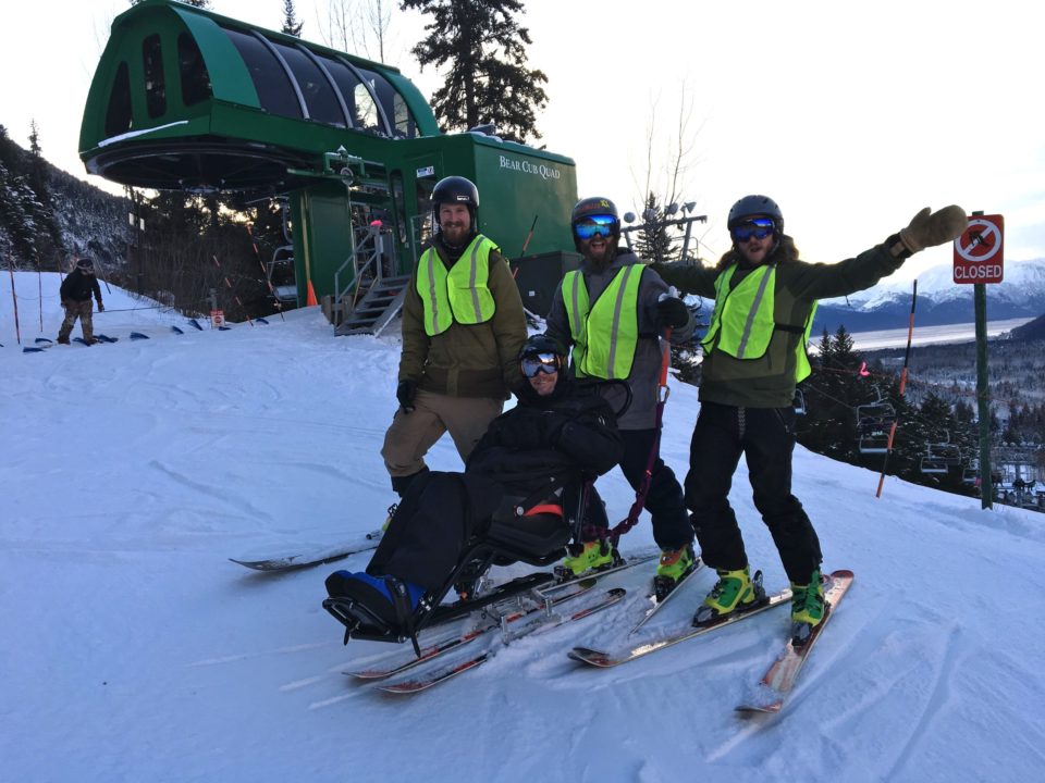 group of smiling guys on the mountain in their skis